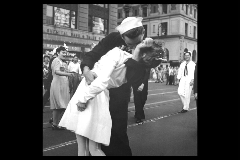 sailor kissing woman in street