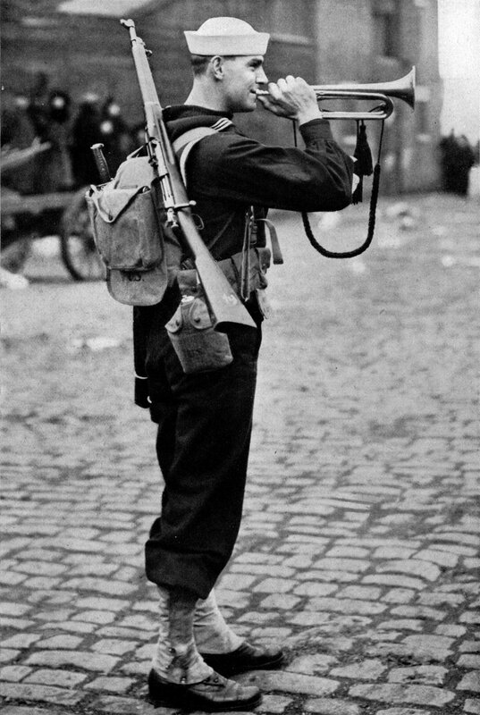 Sailor playing trumpet on cobblestones