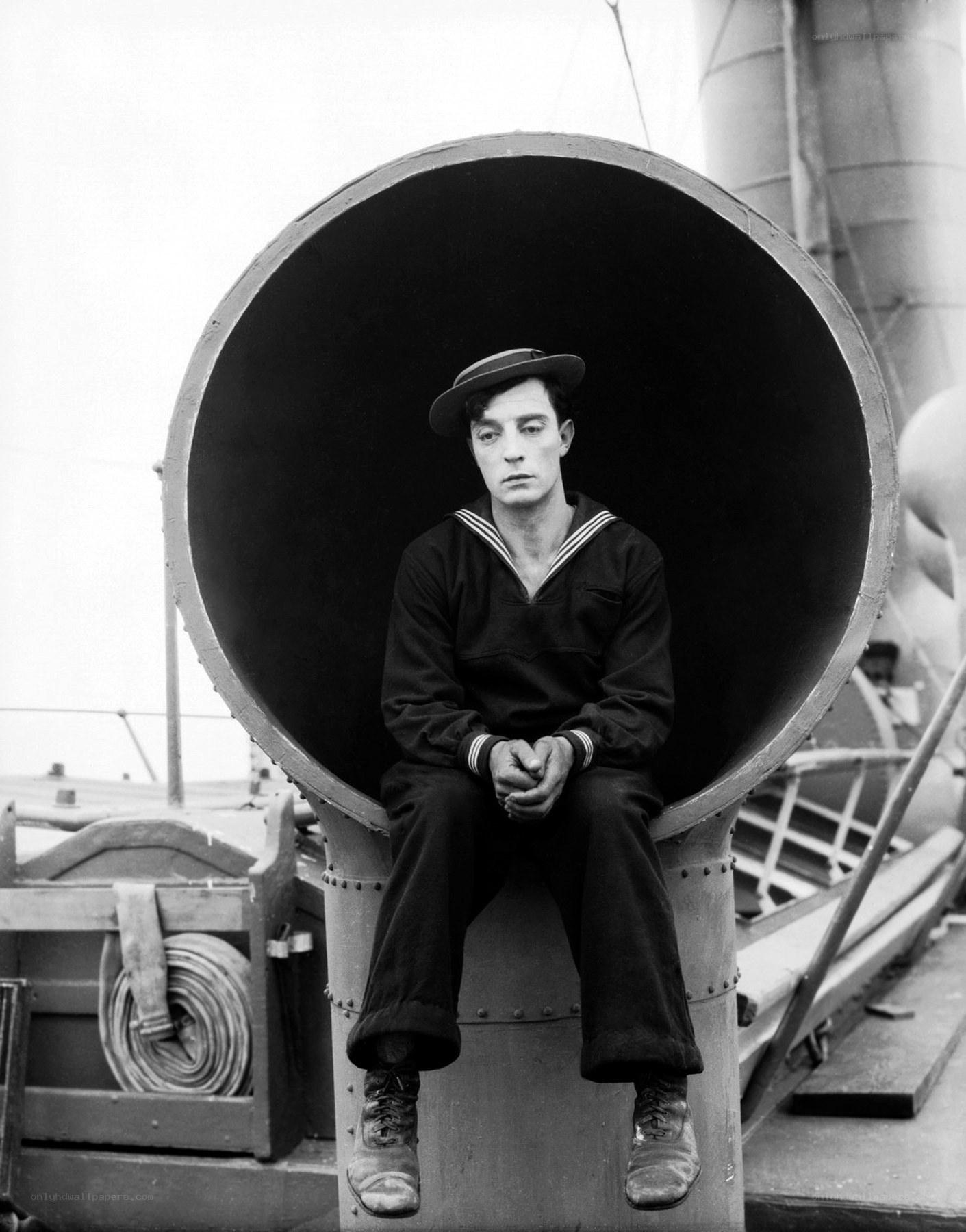 sailor sitting on ship pipe
