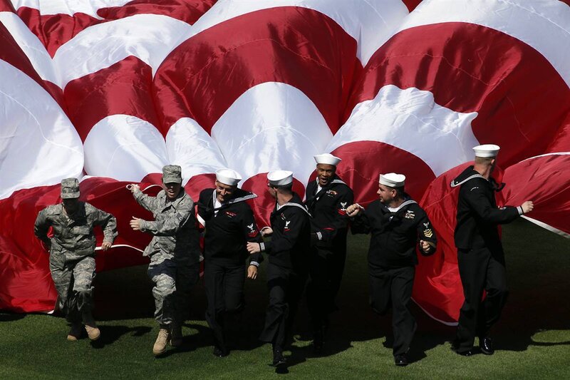 Sailors and soldier with large flag