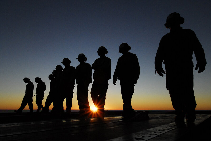 sailors at sunset on deck