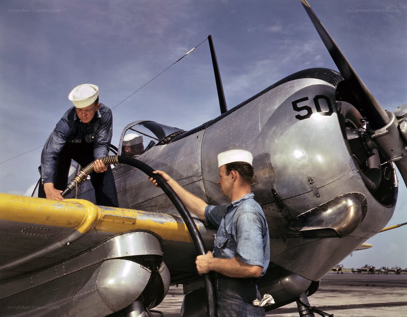 Sailors fueling a plane