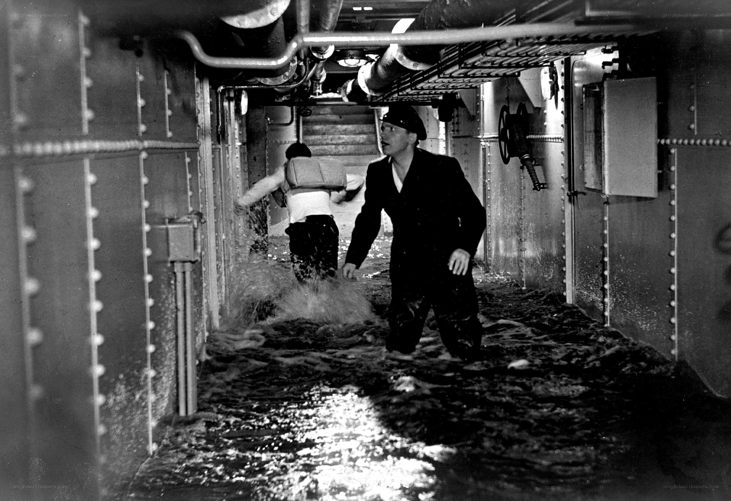 Sailors in flooded ship corridor