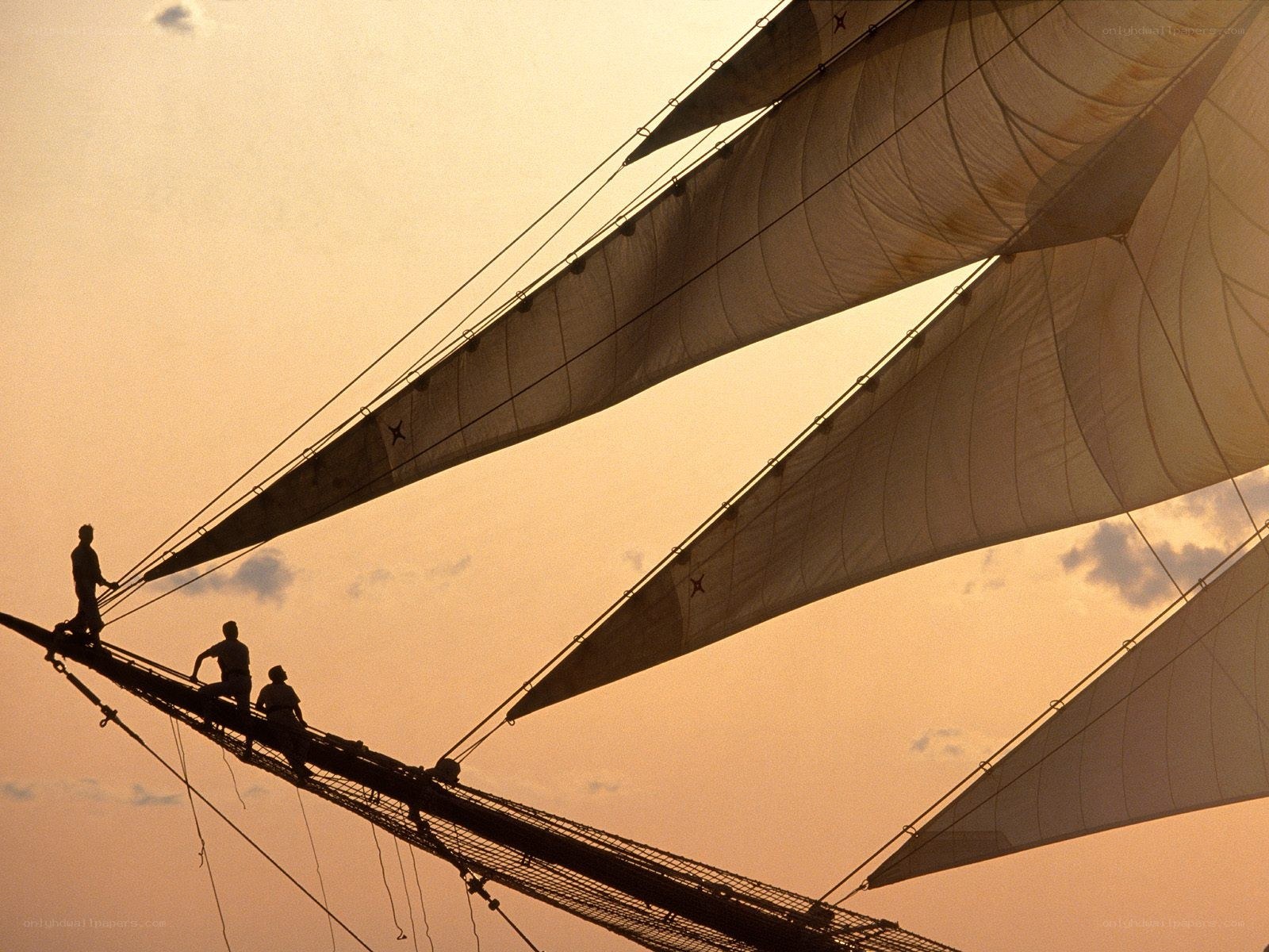 Sailors on a ship at sunset