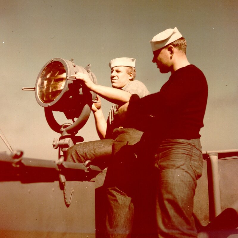 Sailors operating a searchlight