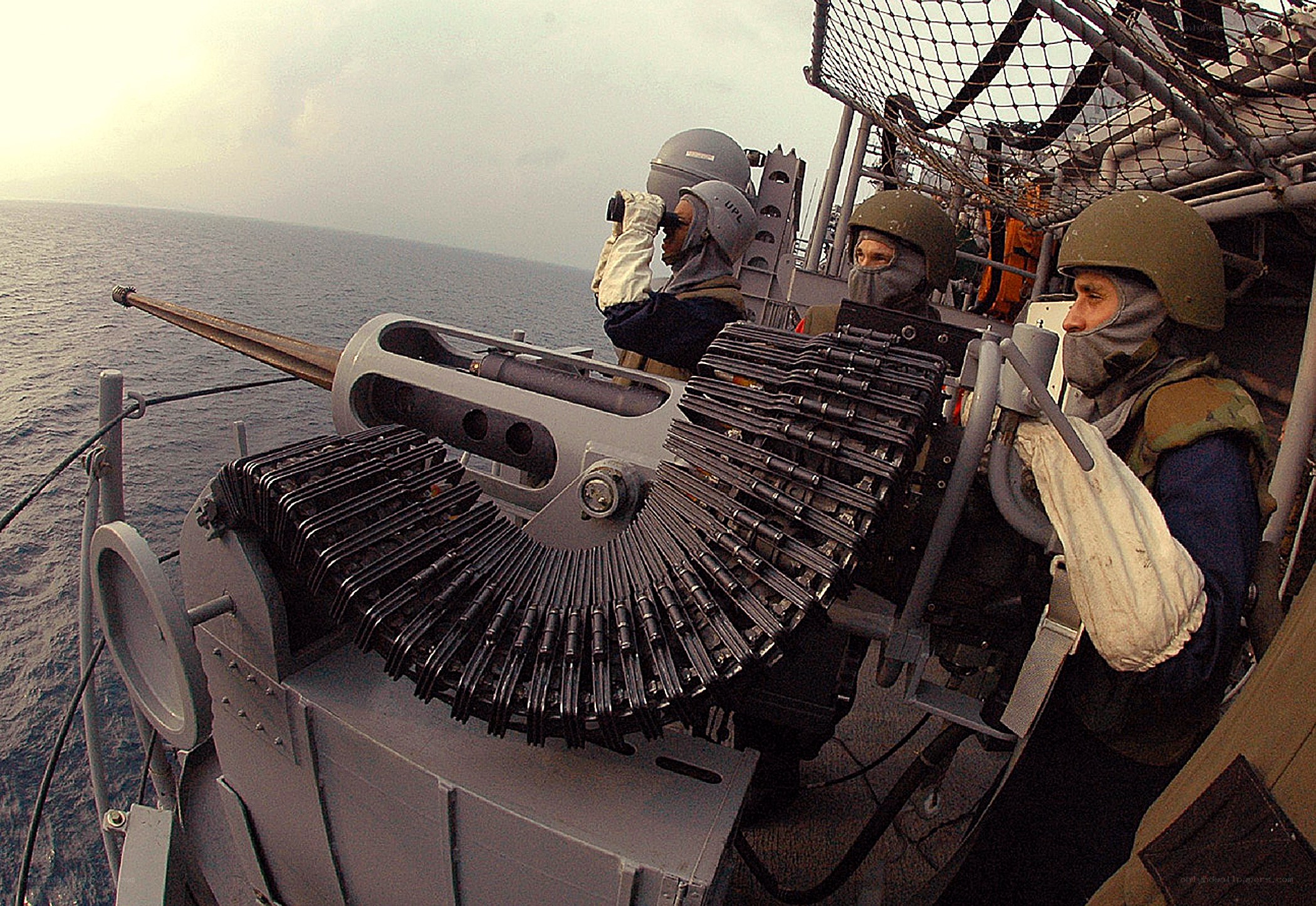 Sailors operating naval gun