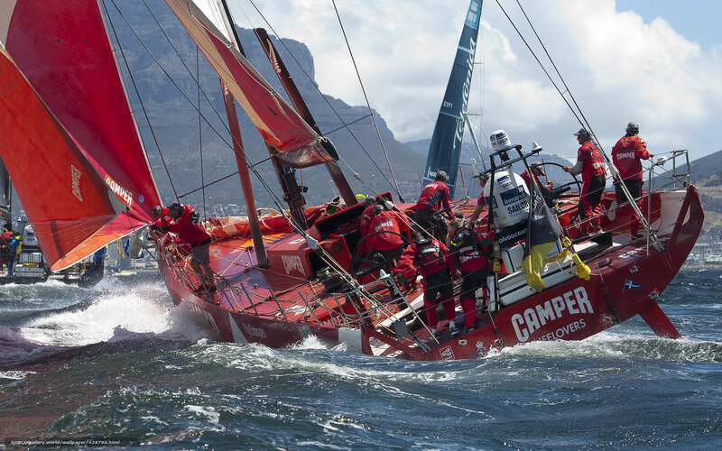 Sailors racing on a red yacht