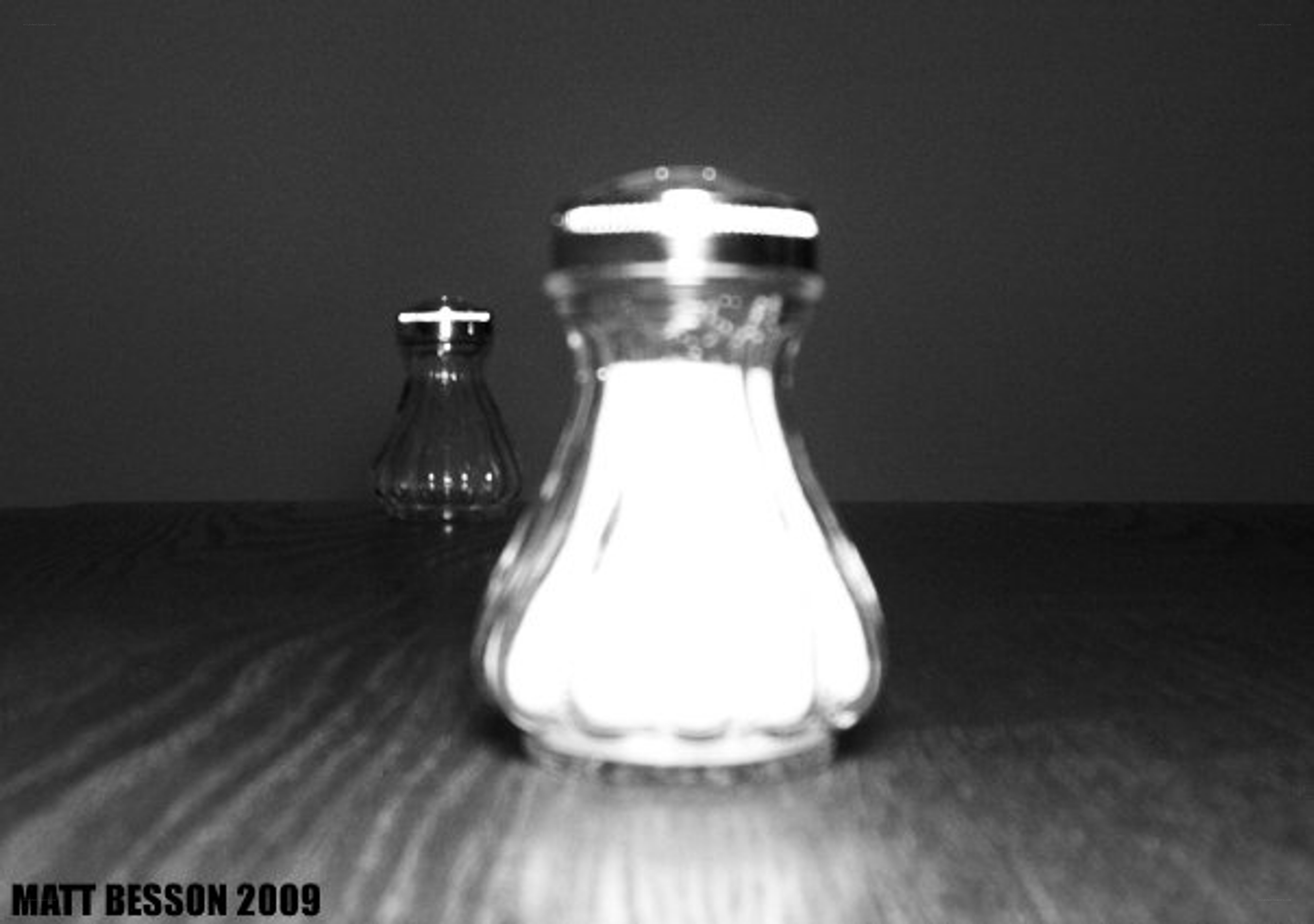 Salt and pepper shakers on table