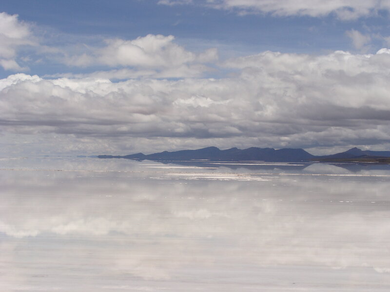 Salt flat with mountain reflection