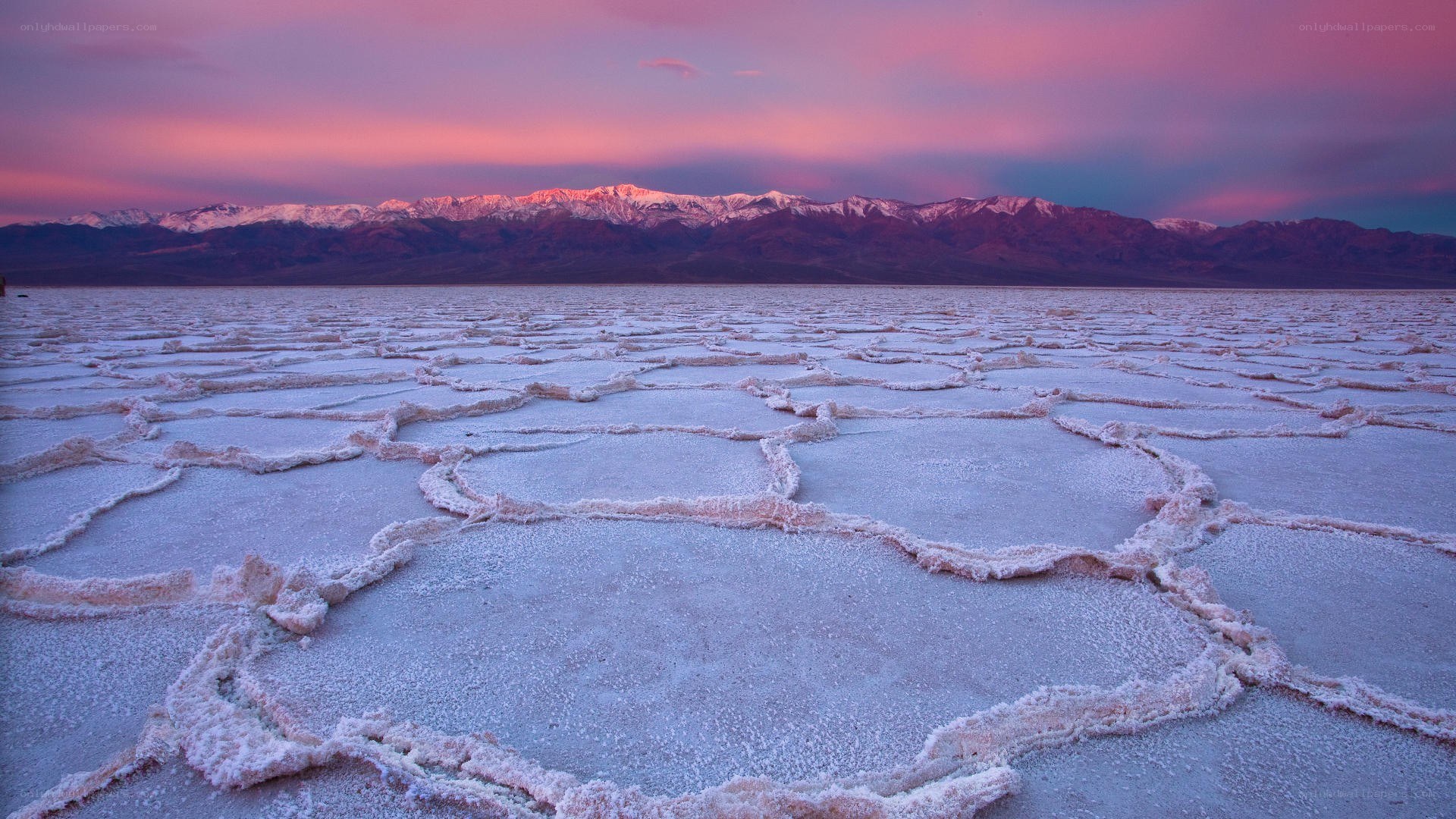 Salt flats at sunset with mountains