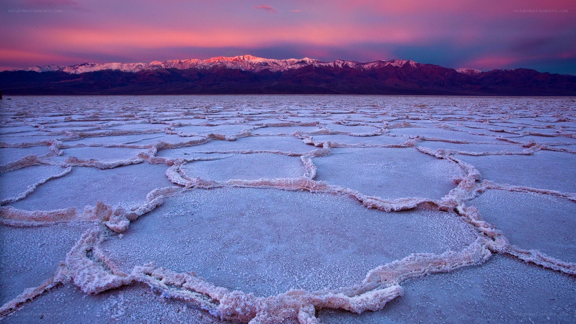 Salt flats at sunset with mountains