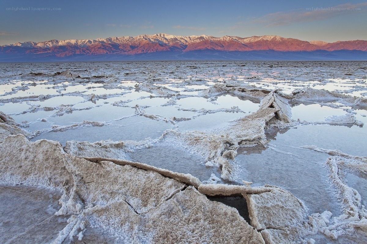 Salt flats at sunset with mountains