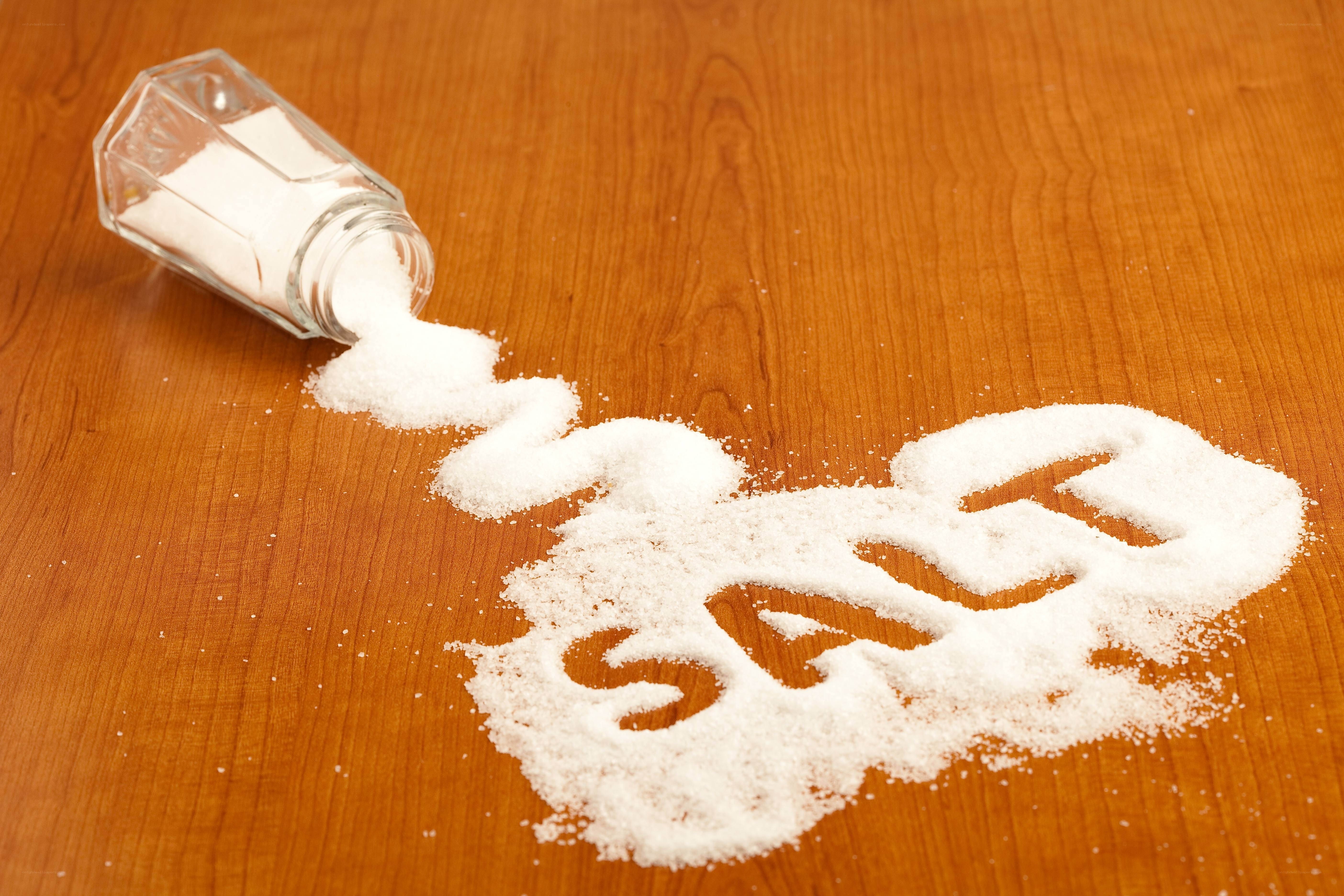 salt spilled on wooden surface
