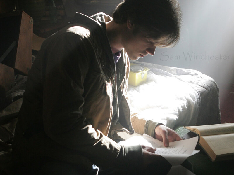 Sam Winchester reading in dim light