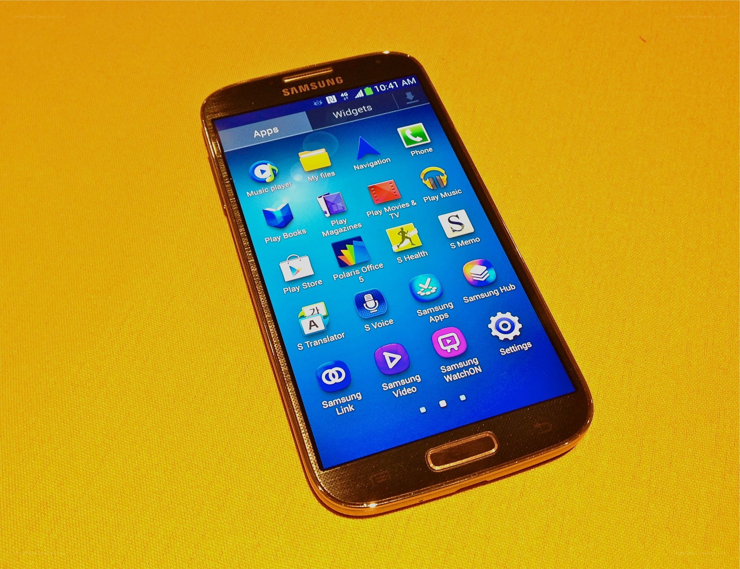Samsung smartphone on yellow surface
