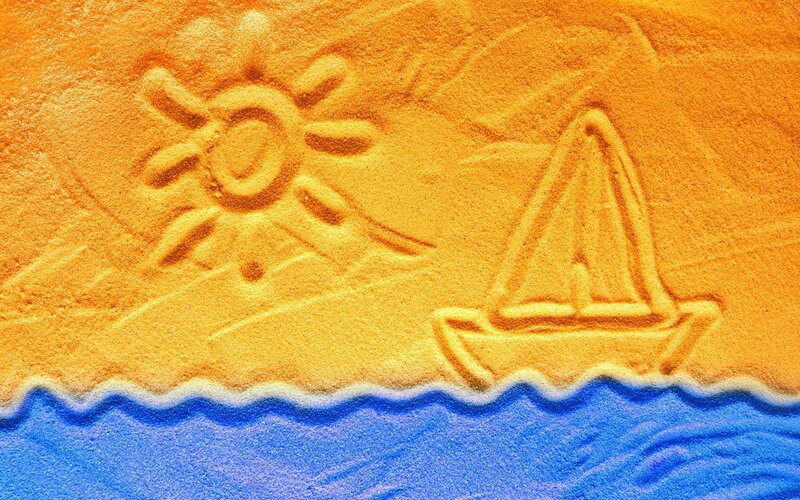 sand drawing of sailboat and sun