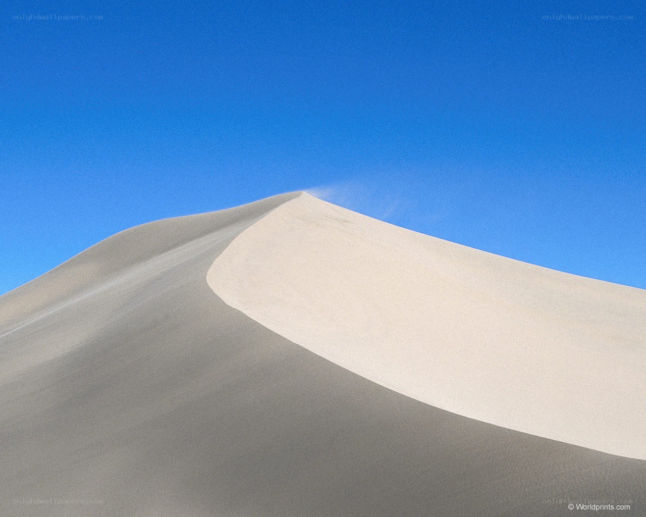 Sand dune under blue sky