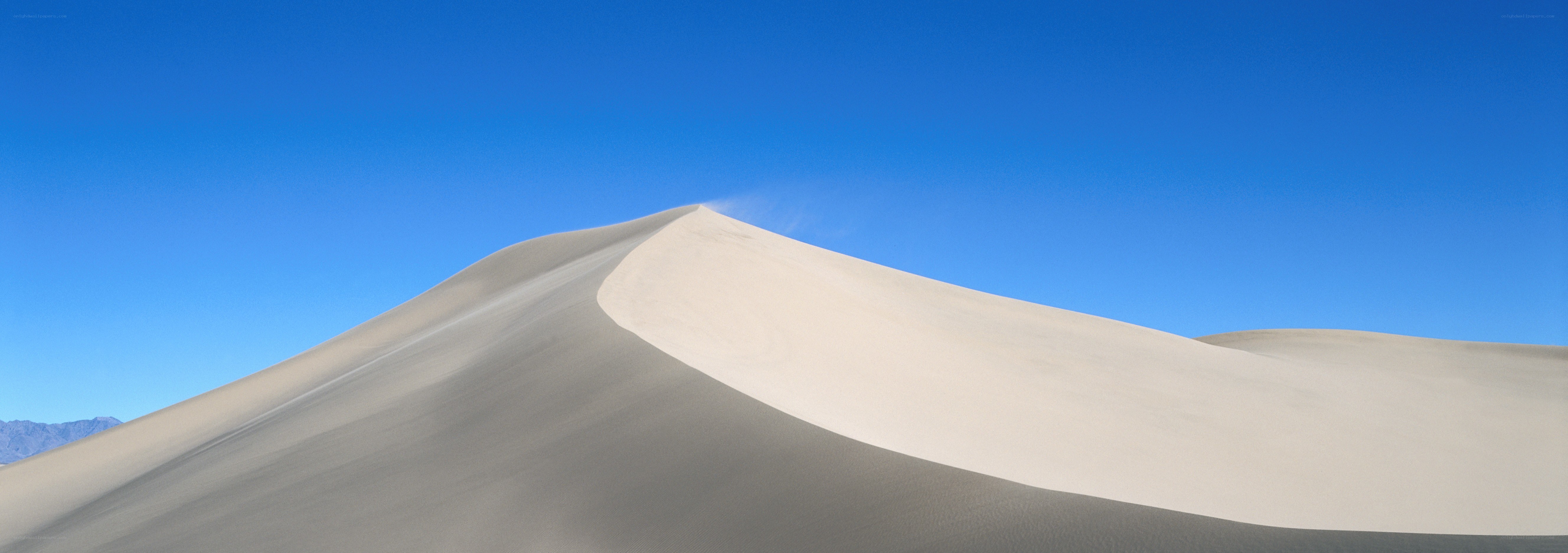 sand dune under blue sky