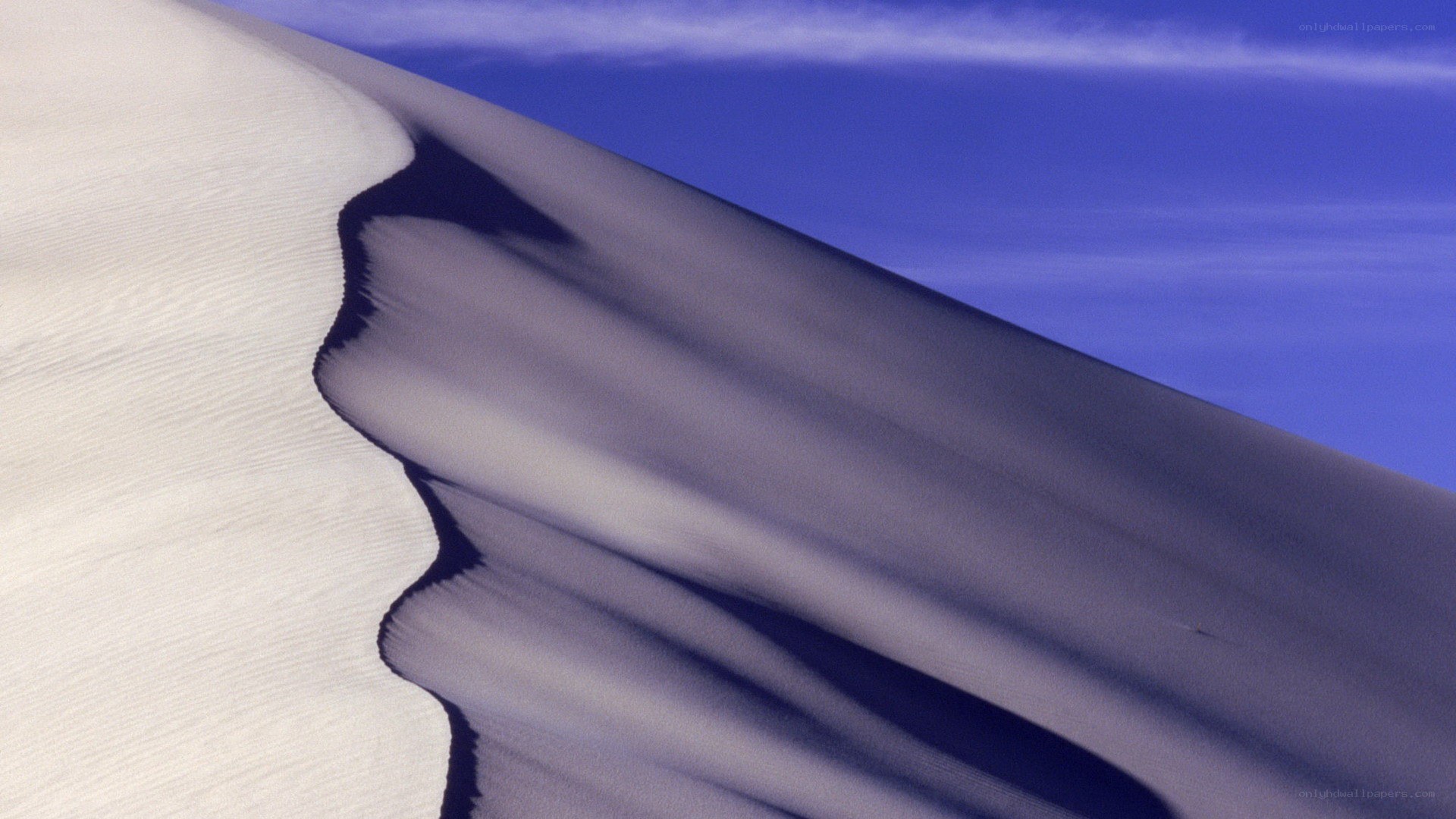 Sand dune under blue sky