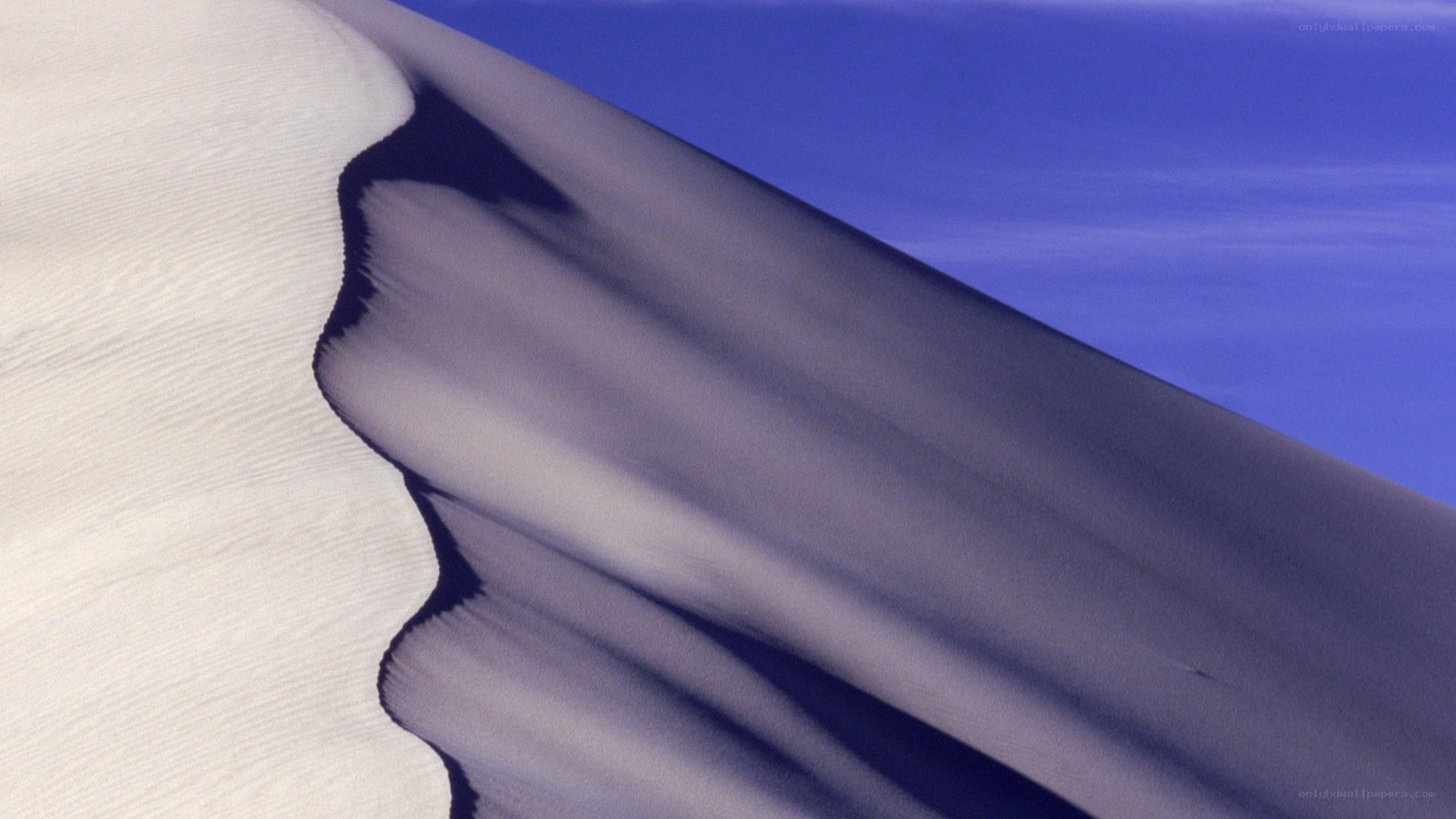 Sand dune under blue sky