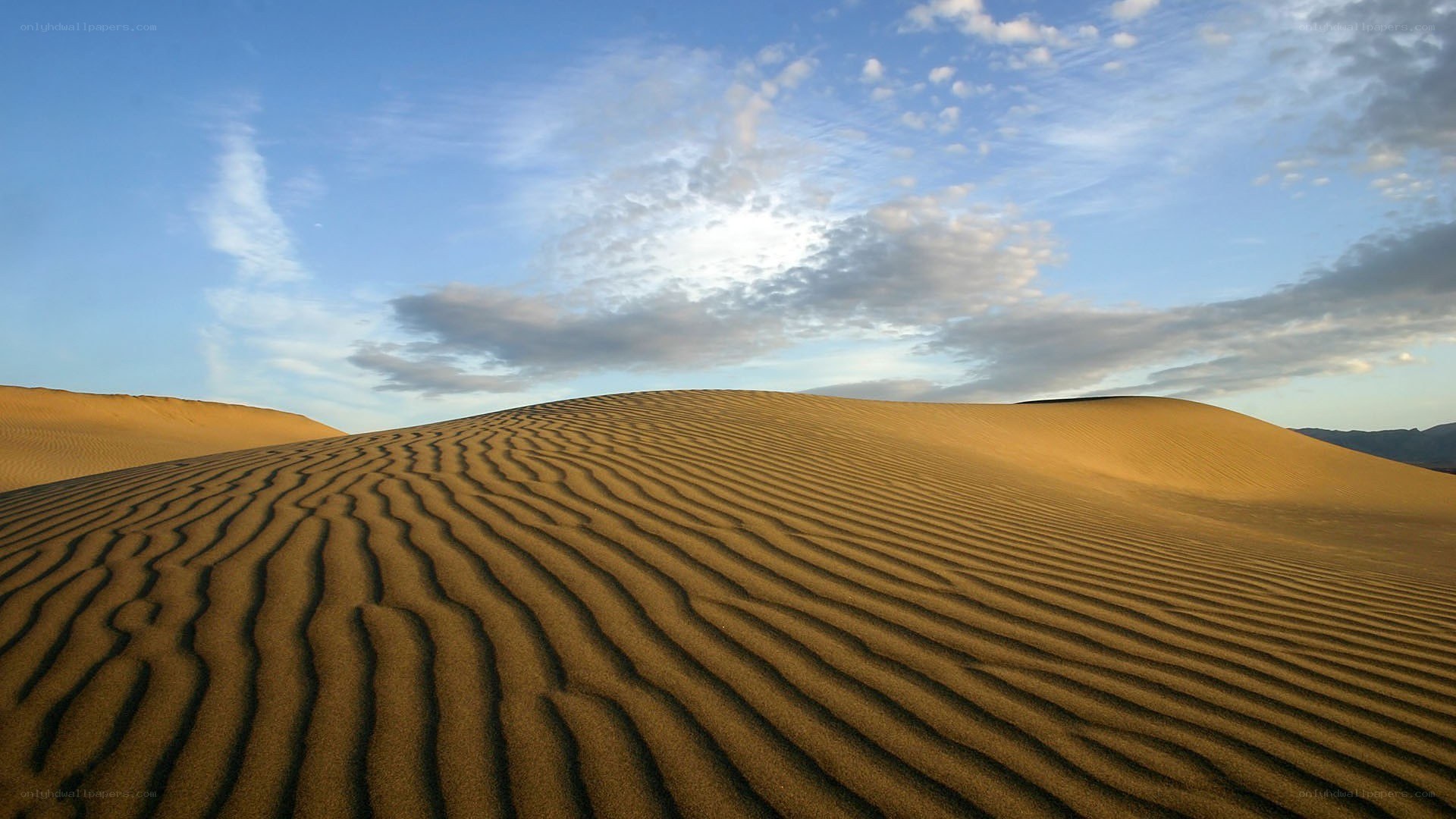 Sand dunes under blue sky