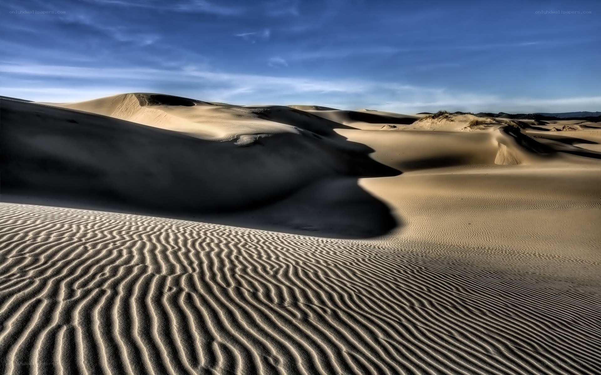 Sand dunes under blue sky