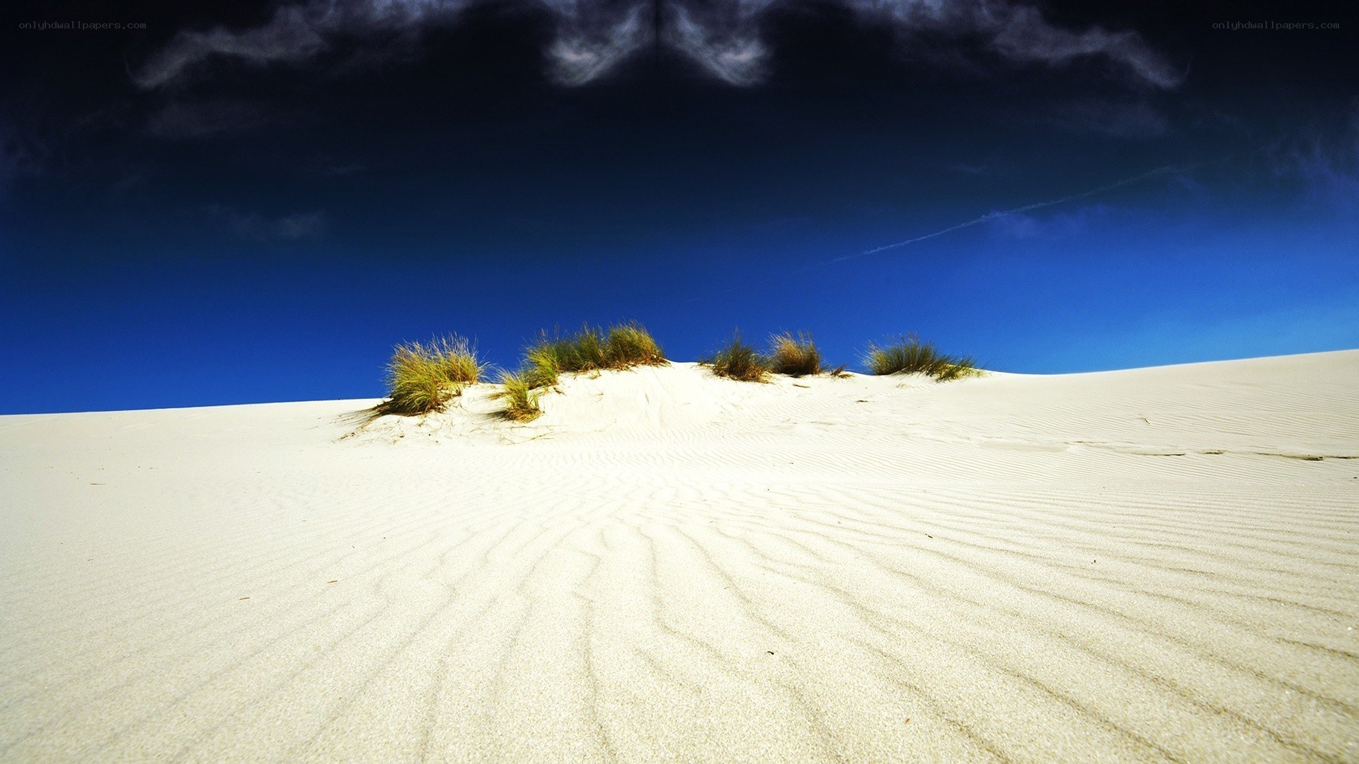 sand dunes under blue sky