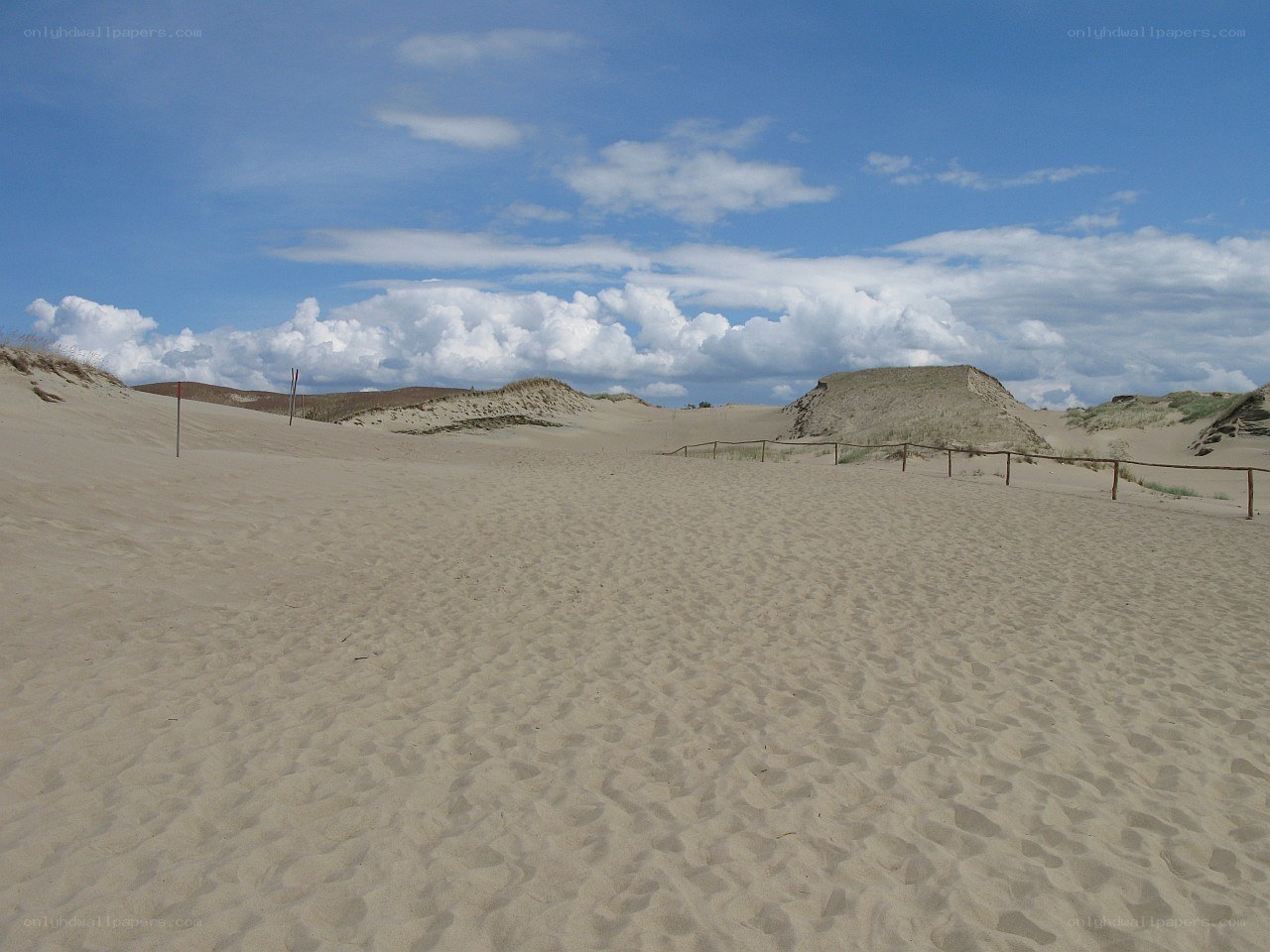 Sand dunes under blue sky