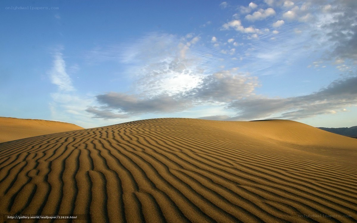 Sand dunes under blue sky