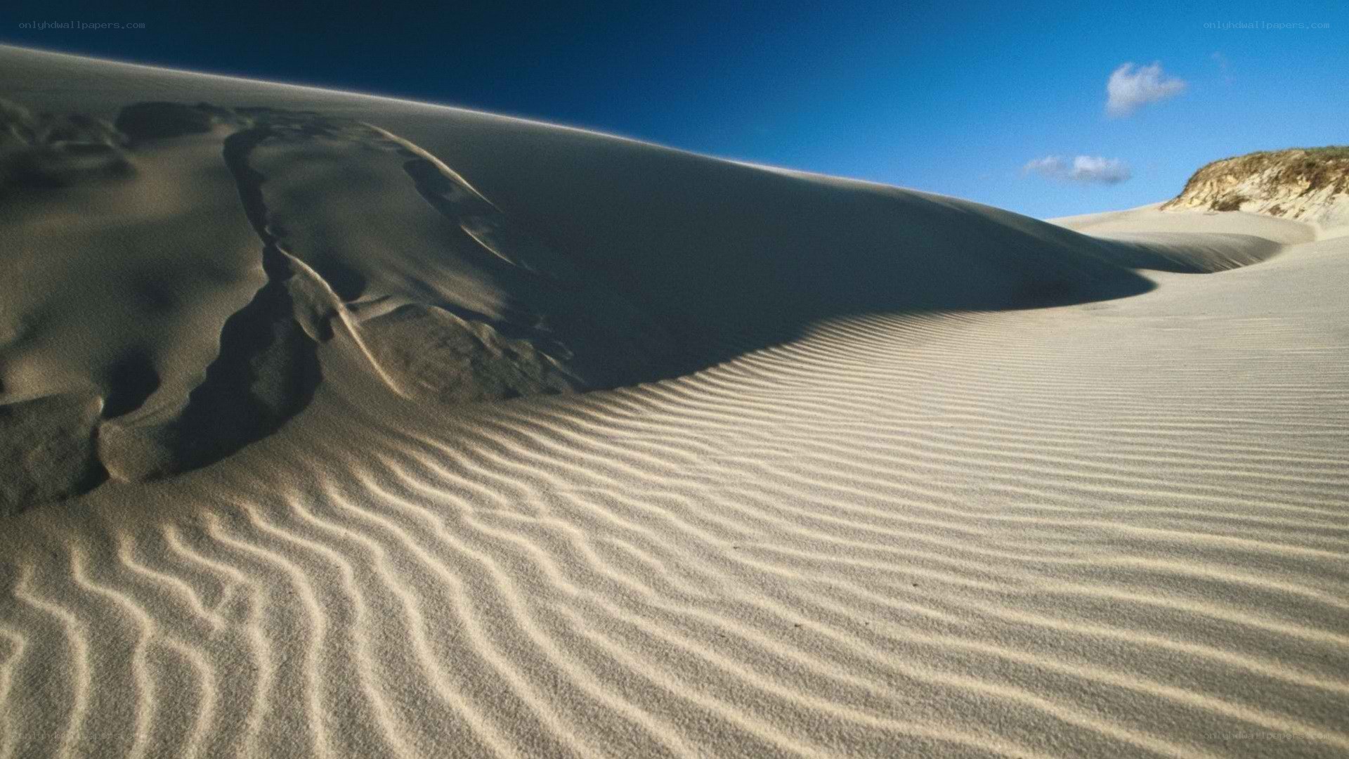 Sand dunes under blue sky