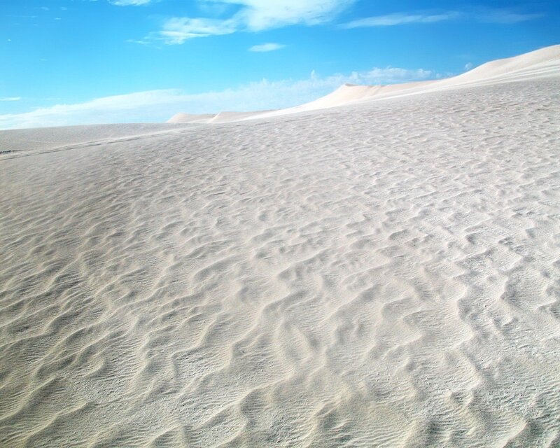 Sand dunes under blue sky
