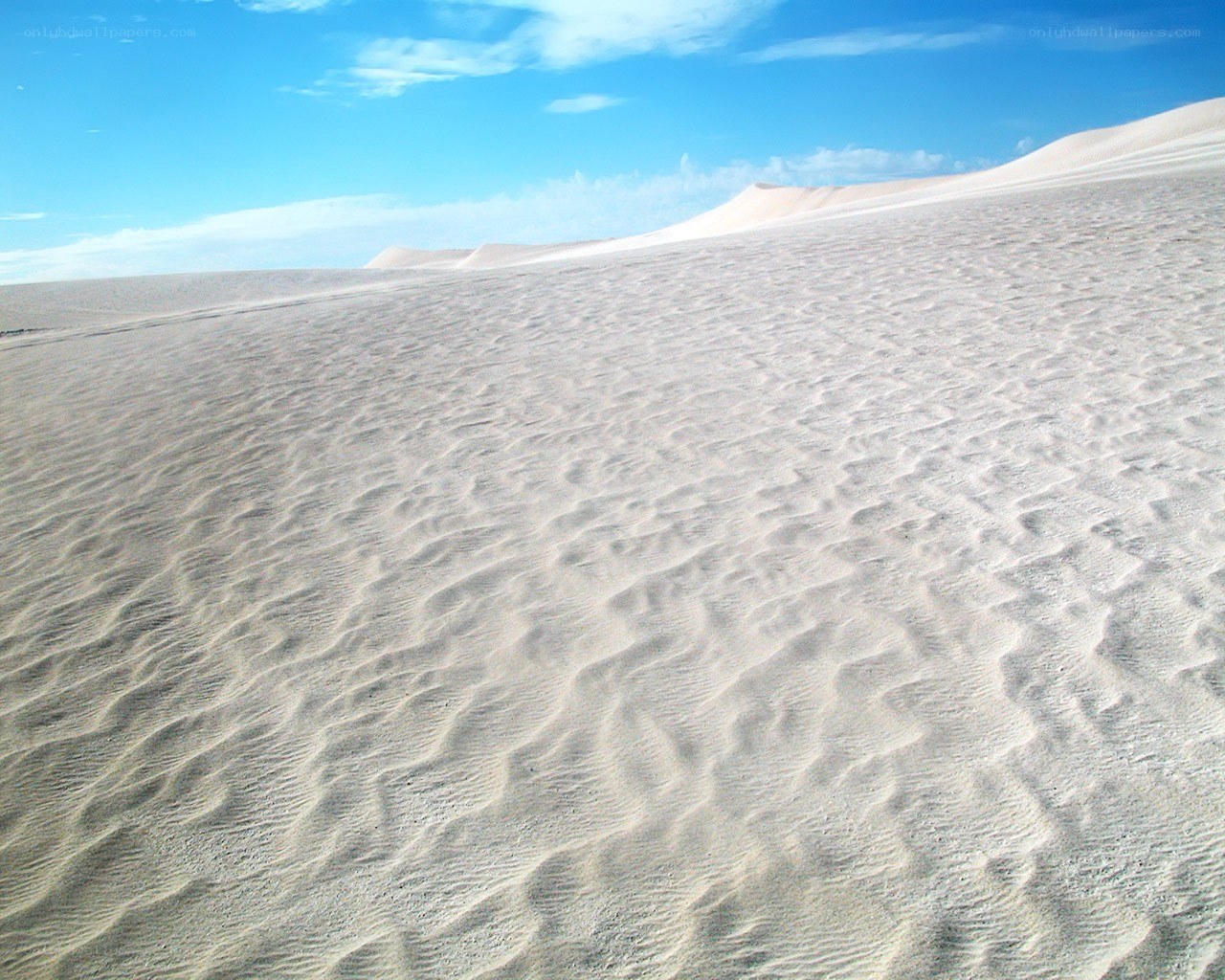 Sand dunes under blue sky