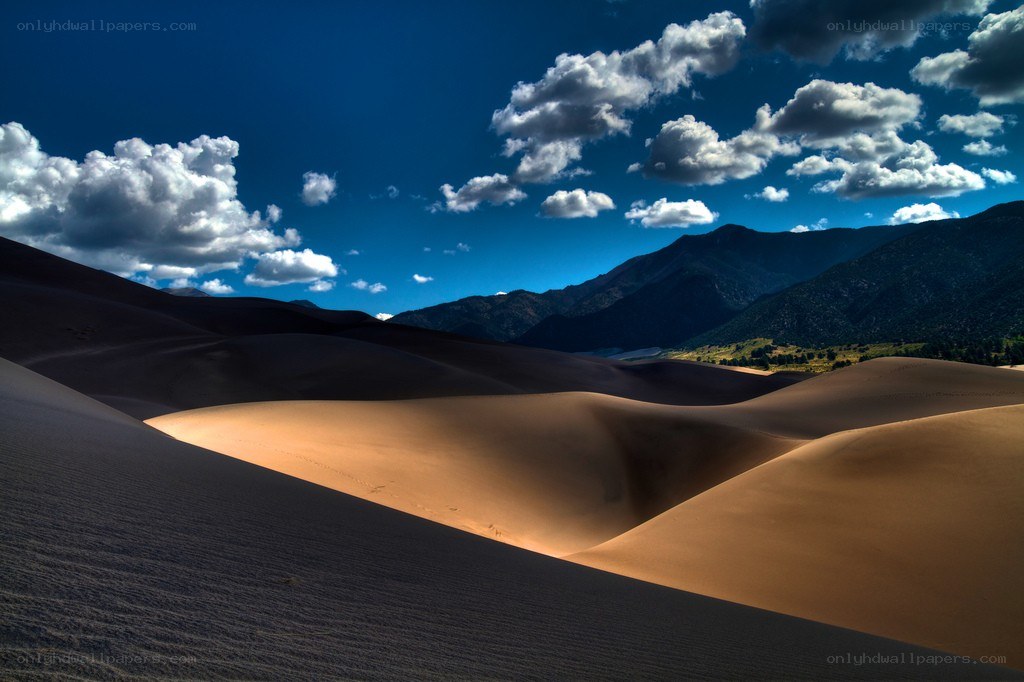 Sand dunes under blue sky
