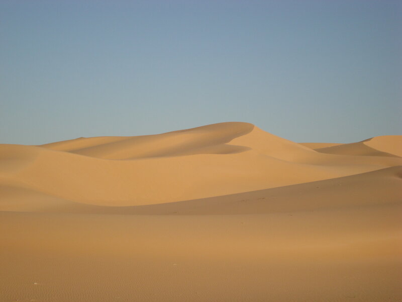 Sand dunes under clear sky