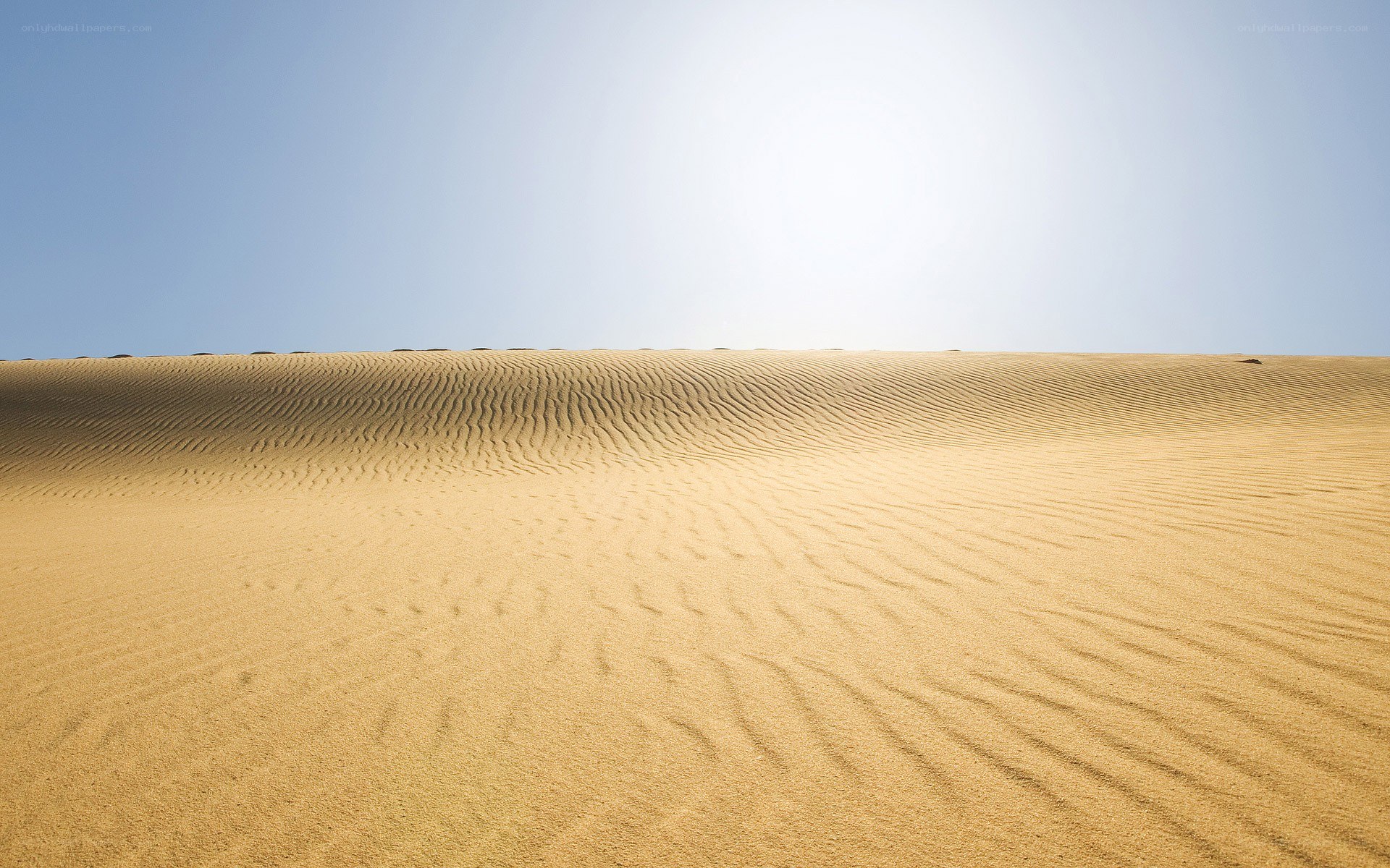 Sand dunes under clear sky