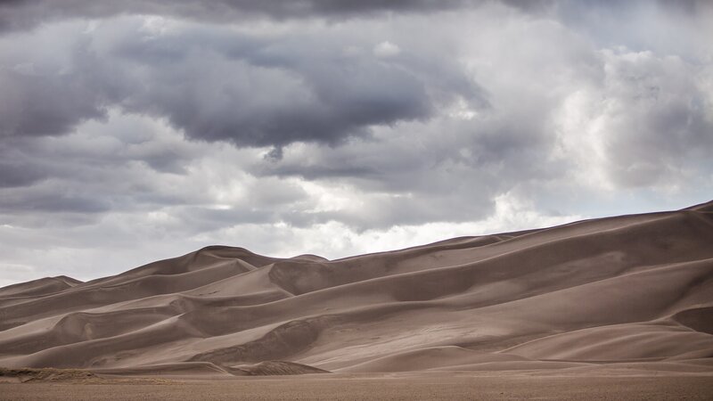 Sand Dunes under Cloudy Sky — Brown, Dramatic
