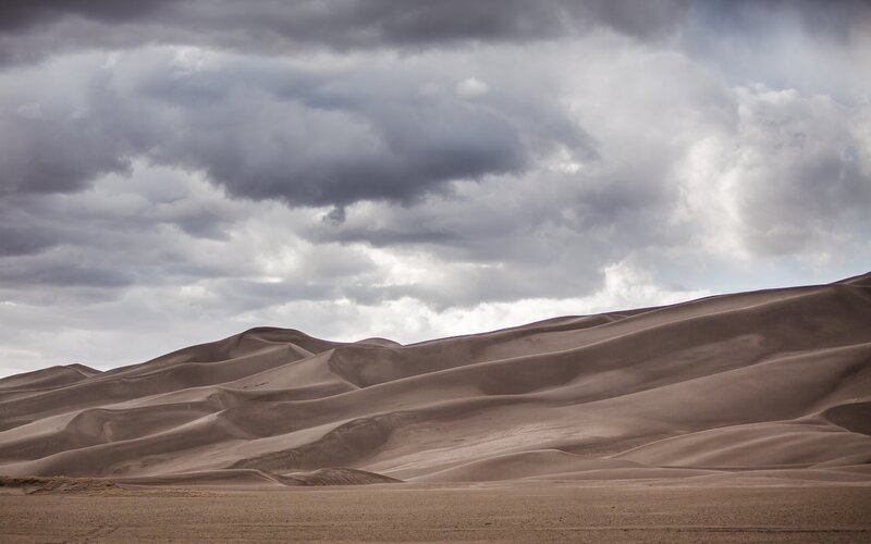 Sand Dunes under Cloudy Sky — Brown