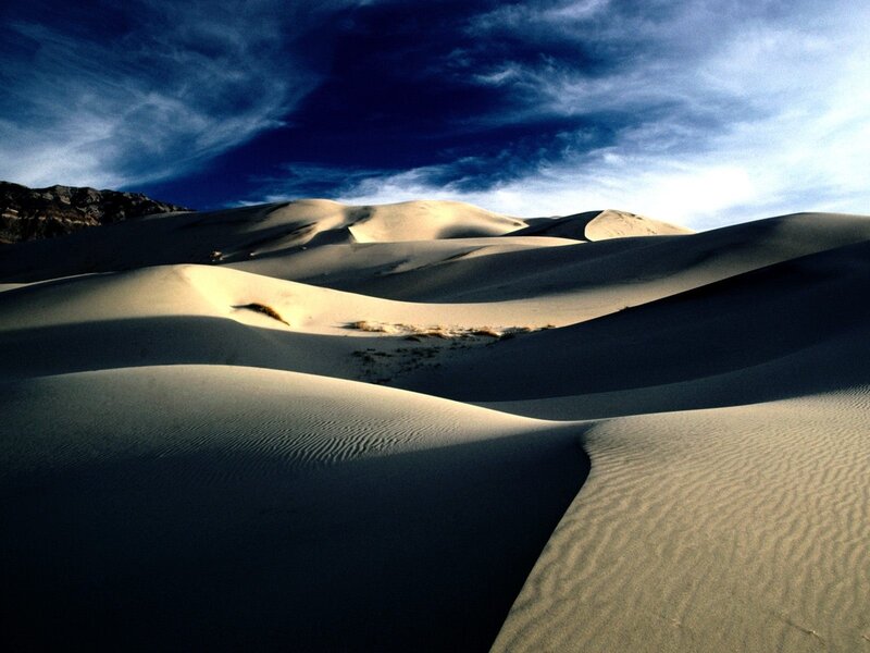 Sand dunes under dramatic sky
