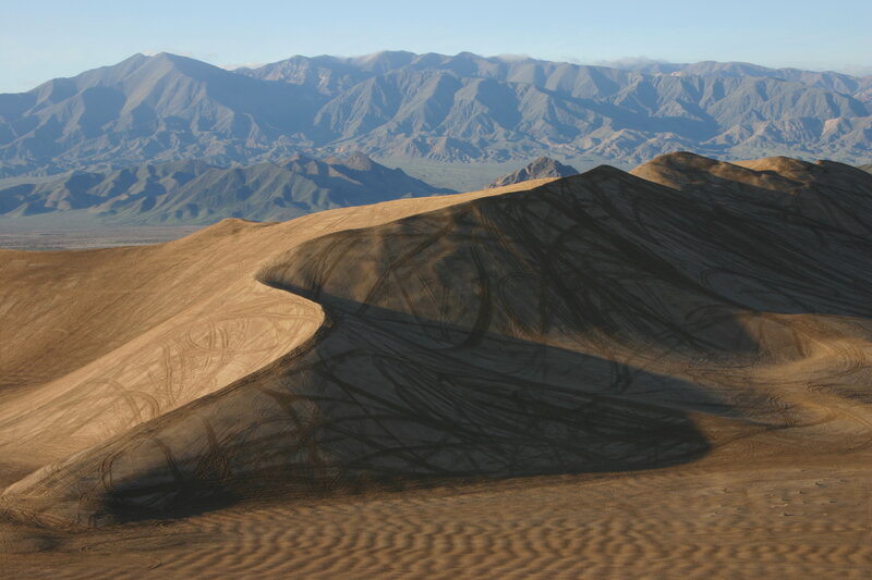 Sand dunes with mountain backdrop