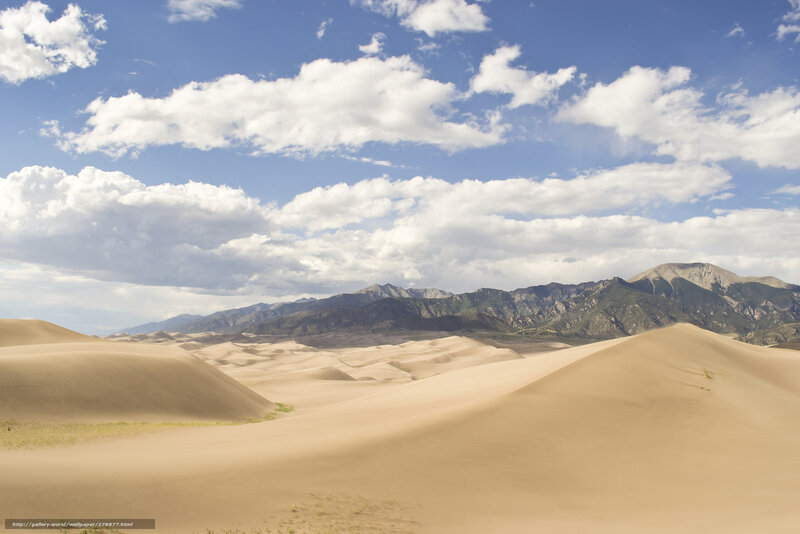 Sand dunes with mountains in background