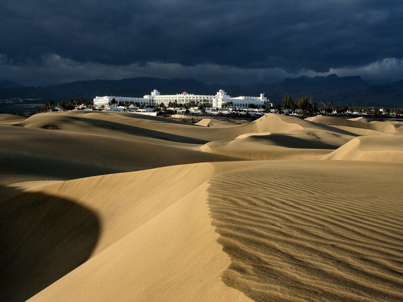 Sand dunes with resort in background