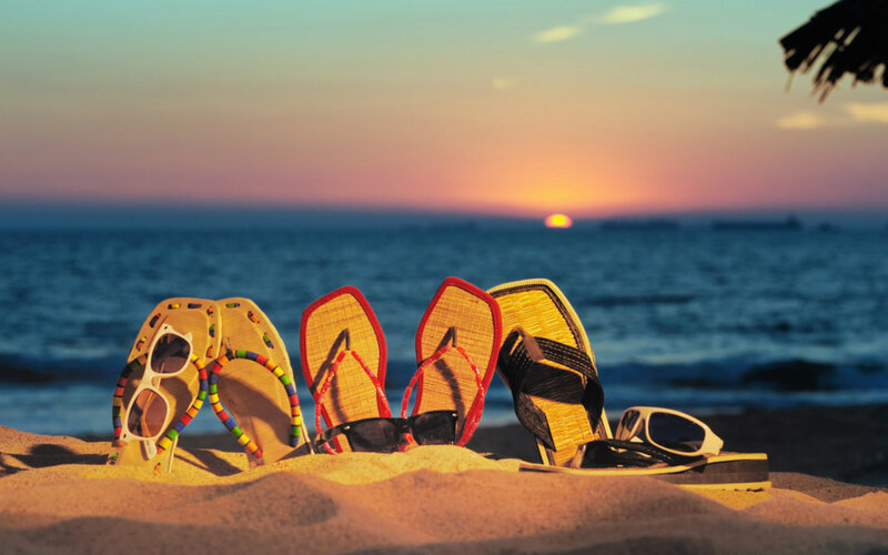 Sandals and Sunglasses on Beach — Orange