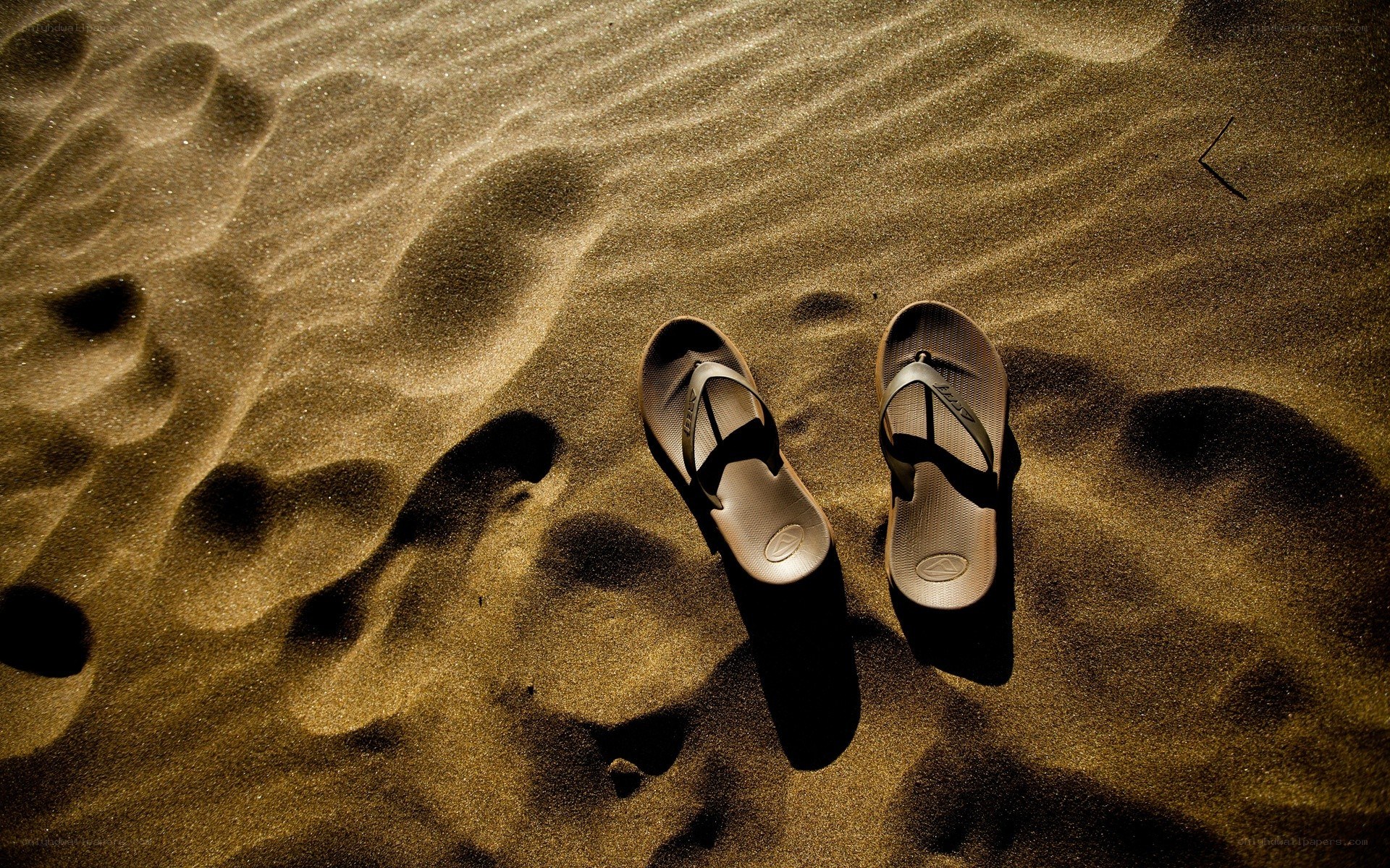 Sandals on a sandy beach