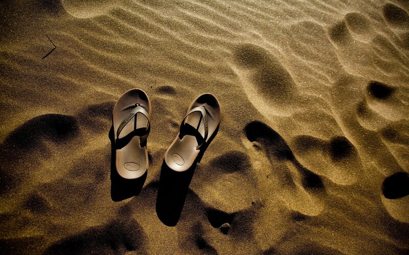 sandals on sandy beach