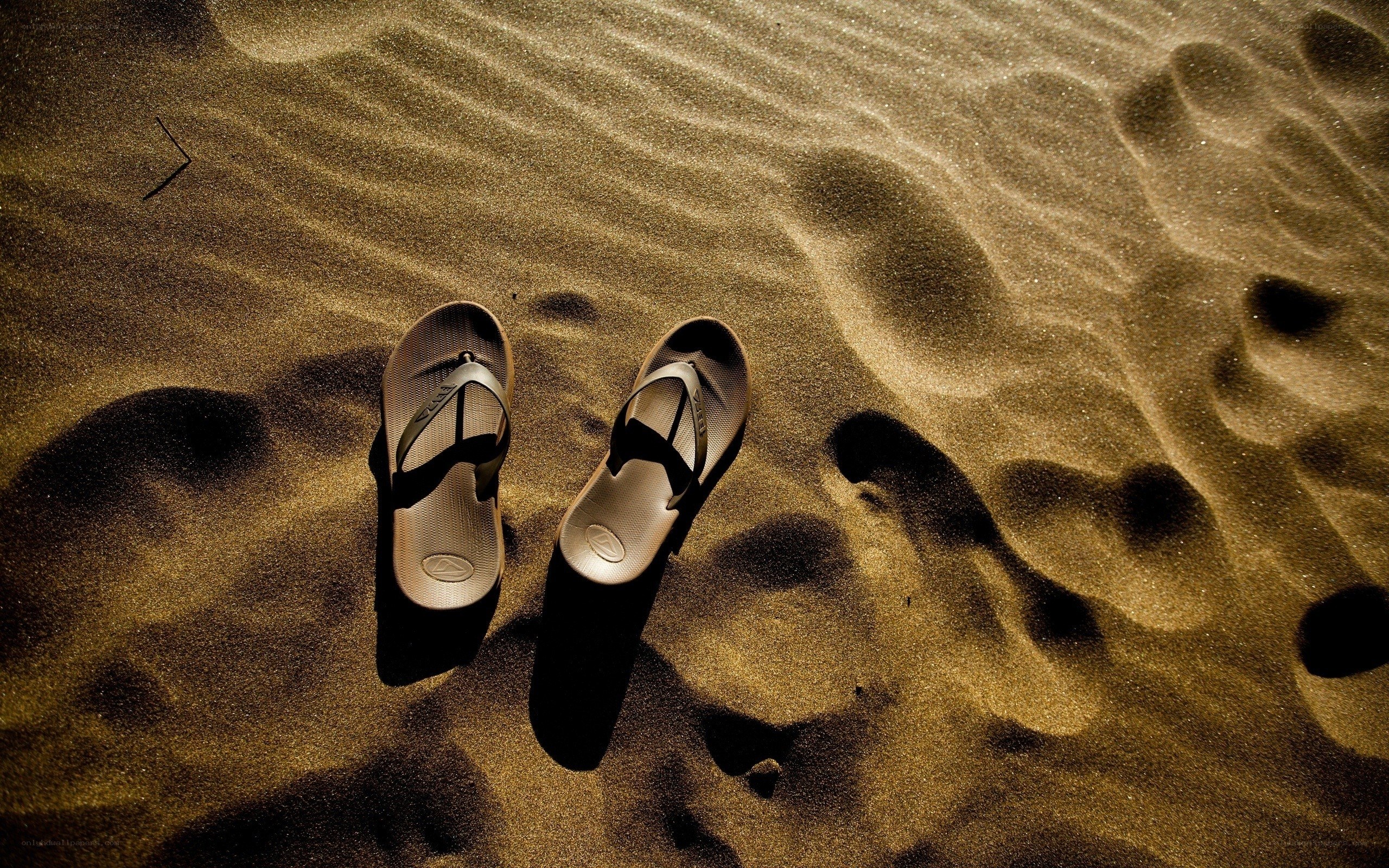 sandals on sandy beach