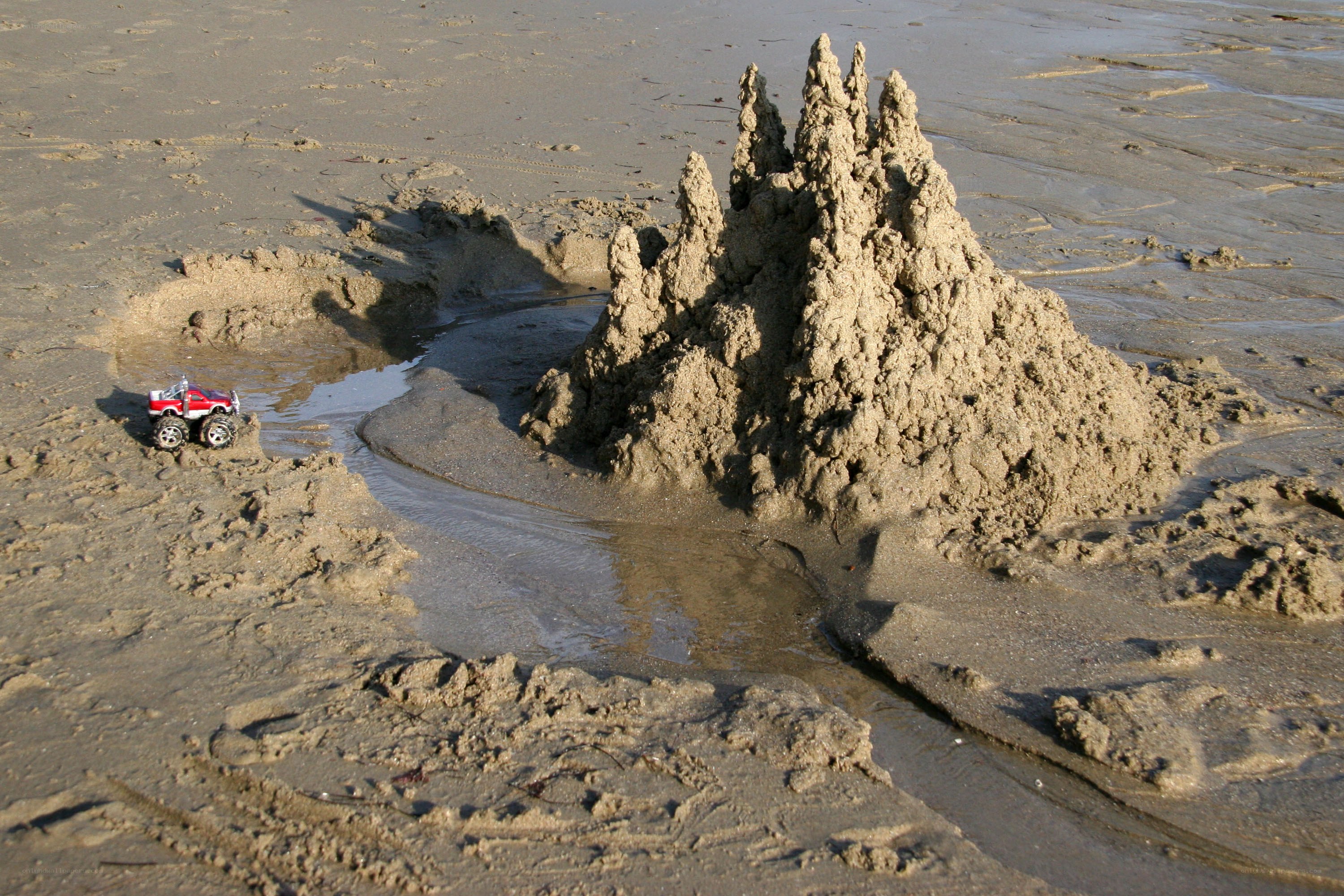 Sandcastle with toy truck