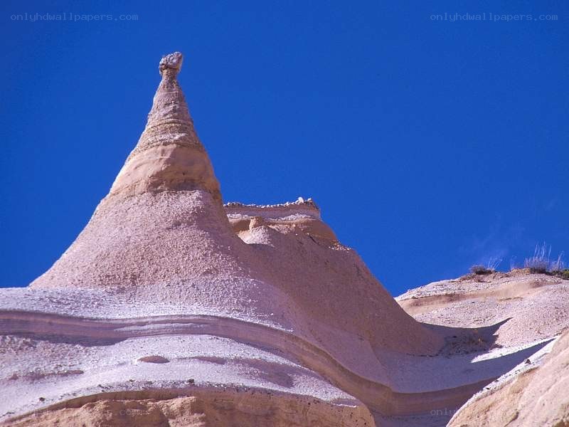 Sandstone spire under blue sky