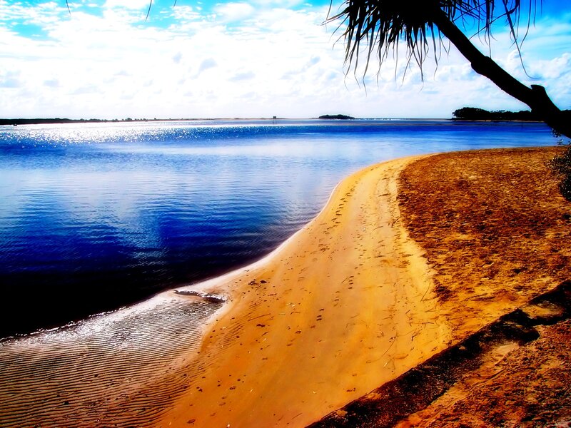 sandy beach by calm water