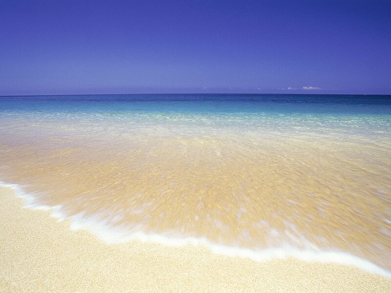 Sandy beach with clear waves