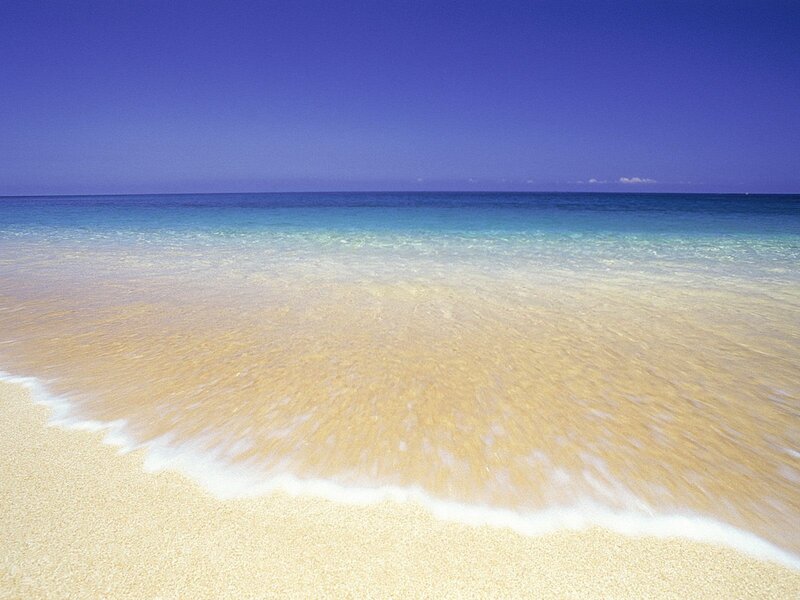 Sandy beach with clear waves